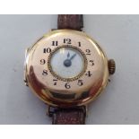 A lady's 9ct gold round cased half-hunter design wristwatch, faced by an Arabic dial