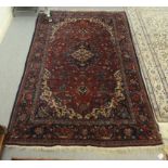 A Persian design rug, decorated with flora, on a red ground  50" x 80"