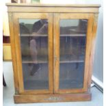 A late Victorian walnut and gilt metal mounted, two door glaze panelled cabinet bookcase  41"h  34"w