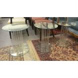 A set of three Greenapple clear plate glass side tables, elevated on an arrangement of rods  19"h