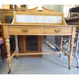 An Edwardian bleached pine washstand with a tiled splashback, over two inline drawers, raised on