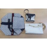 A Gucci holdall; a Chanel white quilted shoulder bag; and a YSL navy blue and white shoulder bag