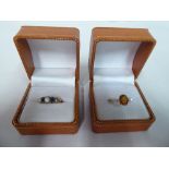 A 9ct gold ring set with alternating pearls and sapphires; and a 9ct gold ring set with an