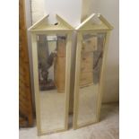 A pair of modern cream painted mirrors, each with a broken arch pediment  44" x 15"