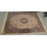 A Persian design rug, decorated with flora, on a cream coloured ground  56" x 80"