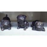 A series of three cast and patinated bronze pug puppies  largest 3"h