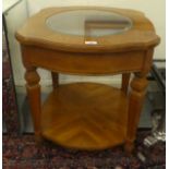 A modern honey coloured oak finished mahogany table with a clear, bevelled glass panel and