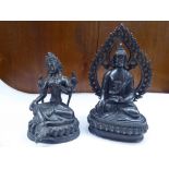 Two Oriental, blackened brass, religious figures, each seated cross-legged  5" & 6.5"h