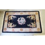 A Chinese cotton rug, decorated with dragons, on a black ground  60" x 36"