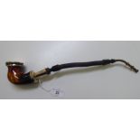 A Middle Eastern smoker's pipe with a flexible stem and metal mounts