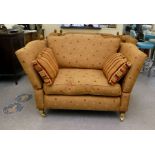 A modern oversized knoll design chair with a high back and arms, upholstered in patterned old gold