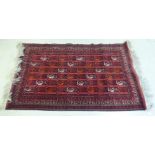 A Turkoman design rug, decorated with animal motifs, on a red ground  44" x 76"