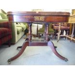 A late Regency mahogany D-shape card table, the rotating foldover, baize lined top raised on a