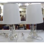 A pair of Ralph Lauren clear glass cylindrical design table lamps with white shades  19"h overall;