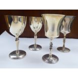 A pair of silver stemmed goblets with bell shape bowls; and a pair of similar with cup design bowls