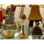 A novelty table lamp, featuring a standing Indian elephant, on a ball and stacked books  24"h; a