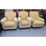 Three similar 20thC armchair, upholstered in yellow fabric, raised on turned forelegs and casters