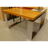 A modern coffee table in the manner of D Pieff Mandarin with a square fruitwood top, raised on steel