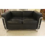 A modern tubular steel chromium framed black hide effect settee  50"w