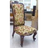 A mid 19thC Continental rosewood framed salon chair with a floral fabric upholstered back and