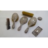 Silver backed dressing table accessories: to include a hand mirror  marks rubbed