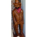 A carved and painted wooden statue, a standing cowboy  77"h