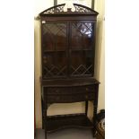 An Edwardian Chippendale inspired blind fret carved and black lacquered mahogany, bow front