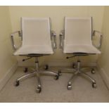 A pair of modern chromium framed Eames style swivel chairs, on casters