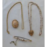 Mixed gold coloured metal jewellery: to include a hinged oval locket; and a bar brooch