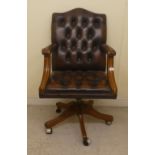 A modern showwood framed Chesterfield style open arm office chair, stud and button upholstered in