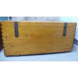 A modern pine chest with a hinged lid and cast iron fittings  22.5"h  47"w