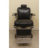 A vintage Belmont adjustable barbers chair with a steel frame, upholstered in black hide,