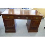 An Edwardian mahogany one piece three drawer, twin pedestal cupboard door desk, on a plinth  28"h