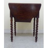 A 19thC 'plum pudding' mahogany Pembroke work table with two end drawers, a wool well and a fall