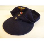 A German Nazi military ski cap with embroidered emblem (Please Note: this lot is subject to the