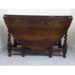 An early 18thC yewwood gateleg table with an oval top and a single end drawer, raised on a