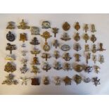 Approx. fifty military cap badges and other insignia, some copies: to include The Tank Corps,