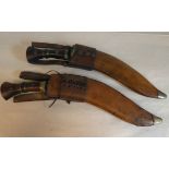 Two identical Great War period Gurkha kukris with rivetted and brass bound wooden handles, the