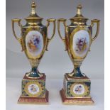 A pair of Austrian gilded porcelain twin handled, shouldered, baluster shape pedestal vases and