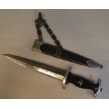 A German SS dagger with a black stained wooden handle and emblems, the blade inscribed 'Meine Ehre