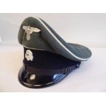 A German SS peak cap with white piping and emblems (Please Note: this lot is subject to the