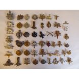 Approx. fifty military cap badges and other insignia, some copies: to include The West Riding,