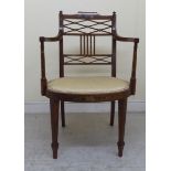 An Edwardian satin mahogany framed elbow chair, allover painted with trailing flora and musical