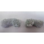 A pair of 19th/early 20thC jadeite figures of mythical beasts, each carved in typical manner with