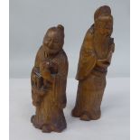 A pair of 18th/19thC Chinese carved sandalwood figures, depicting scholars bearing sacred objects