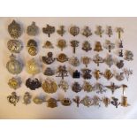Approx. fifty military cap badges and other insignia, some copies: to include King's Own Scottish