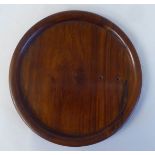 An 18th/19thC Chinese turned Huanqhuali wood tray with an everted rim and typical 'ghost' to the