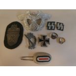 German military and associated items, viz. a police helmet plate; a 1936 Iron Cross; an arm