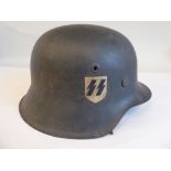 A World War II German SS steel helmet with one decal, chinstrap and hide liner (Please Note: this