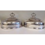 A pair of early 20thC silver plated oval meat domes with cast ring handles and the engraved cypher